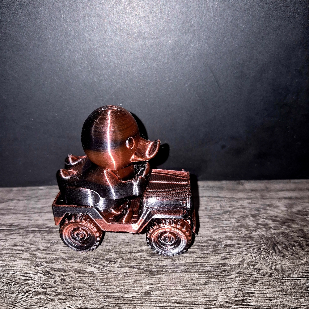 Copper Duck Figurine on Miniature Car